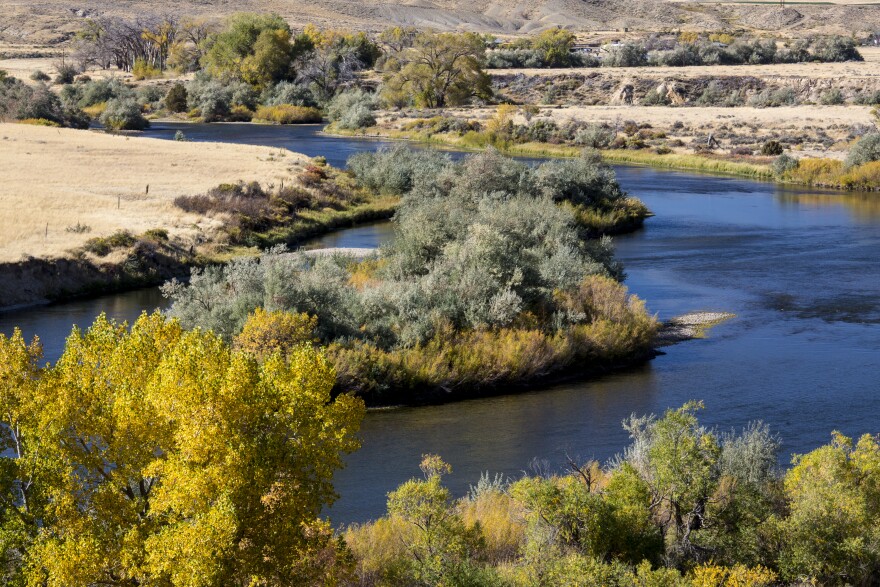 The image is of the North Platte River system in an area where it runs through Casper. This image of the river shows the river banks on either side and the land masses that are in the middle of the river, along with the landscape beside and behind the river.